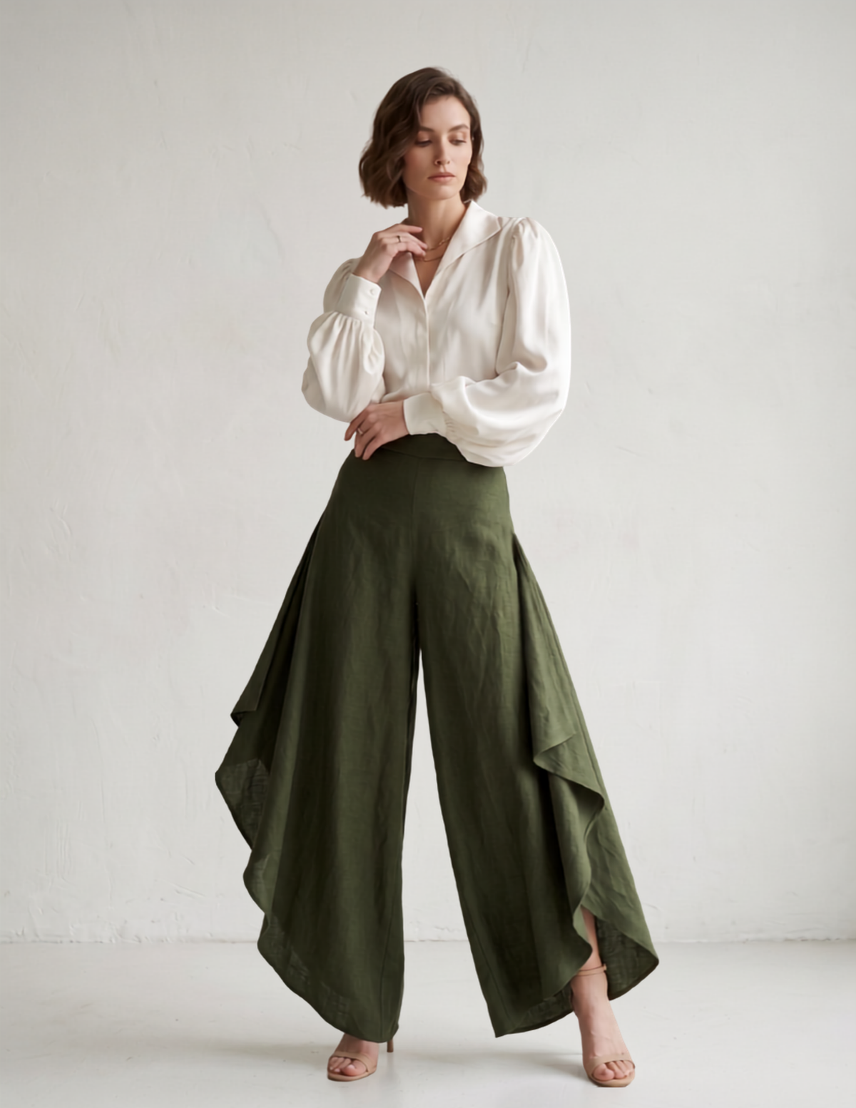 Woman modeling the fi nished Clara split leg palazzo trousers in olive green linen. An elegant and easy sewing pattern for wide leg pants.