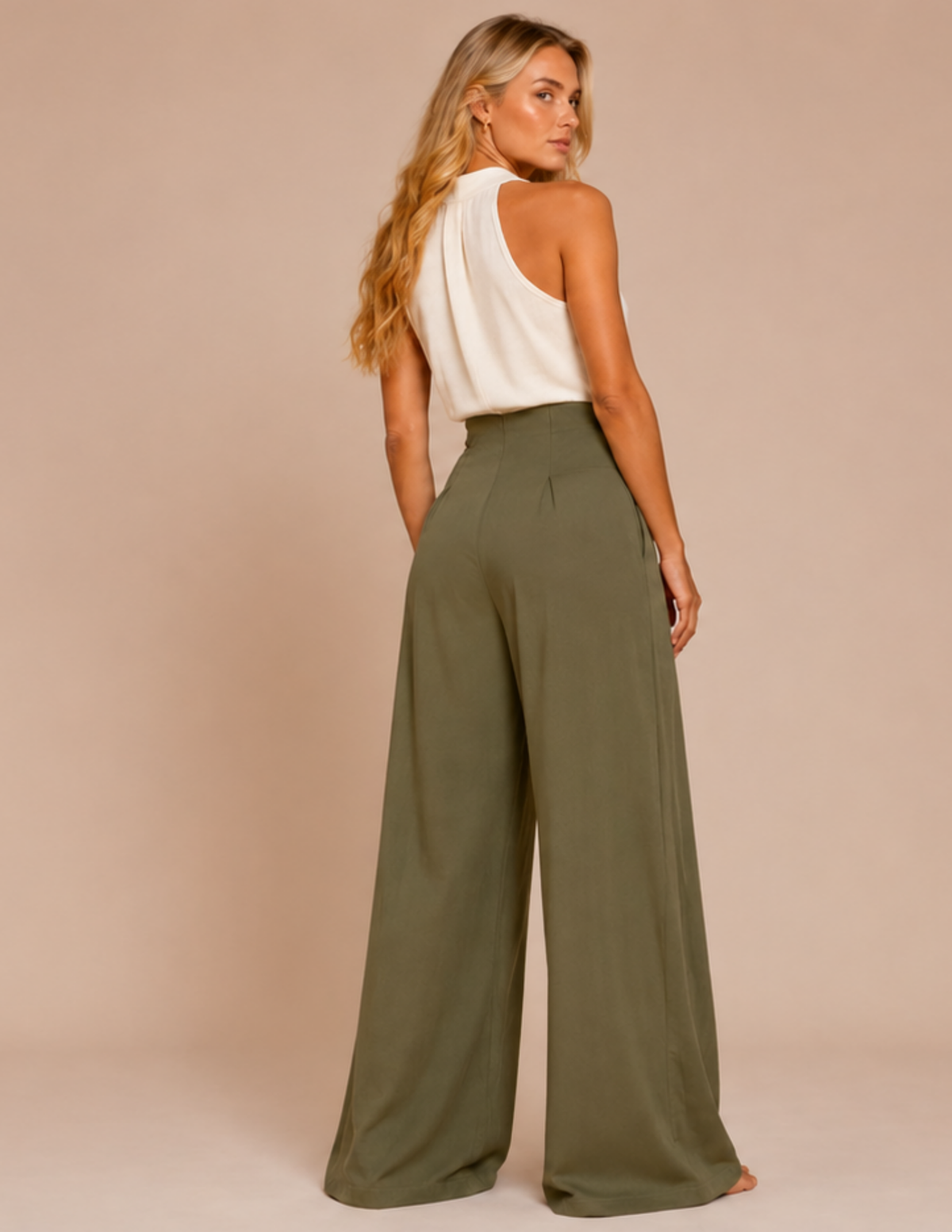 Woman wearing a white top and olive green wide-leg pants on a beige background
LARA high waist wide leg trousers sewing pattern back view with back darts and clean finished hem