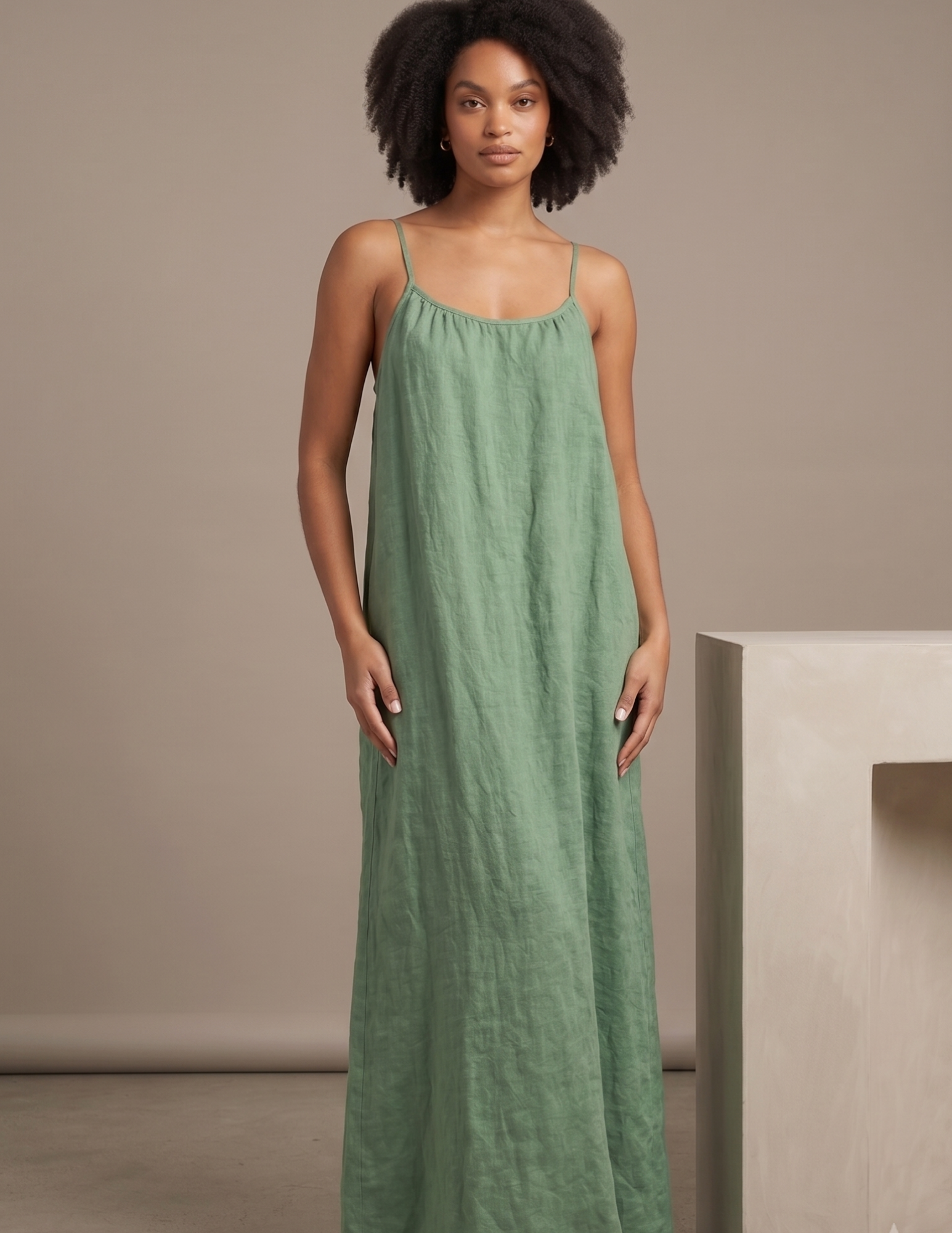 Front view of the 
Amazonie linen maxi 
dress featuring a 
relaxed A-line 
silhouette, gathered 
neckline and elegant 
summer design.