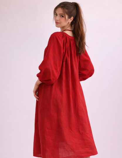 Bianca dress sewing pattern sewn in red fabric, back view showing gathered neckline and relaxed silhouette