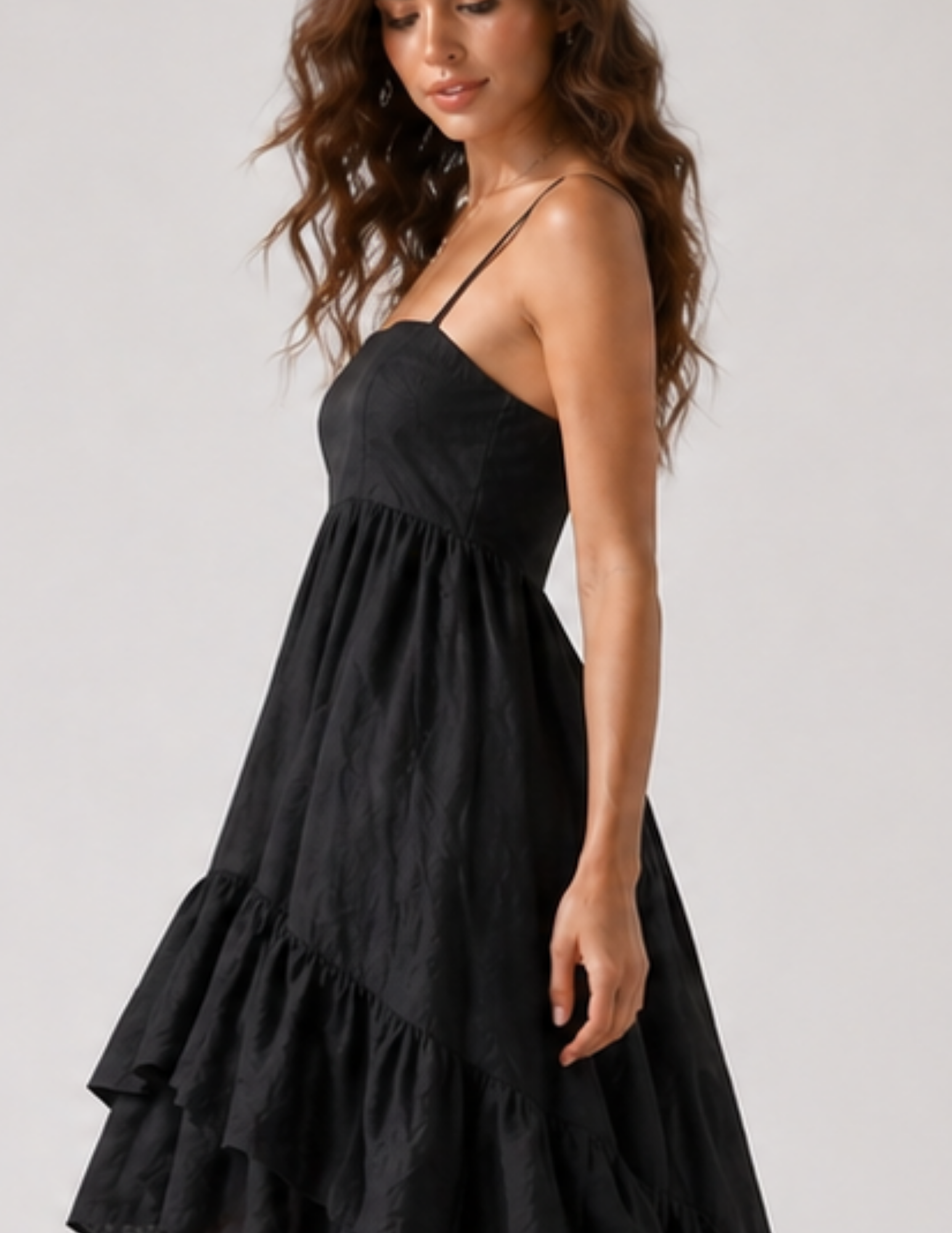 Woman wearing a black dress with a plain background