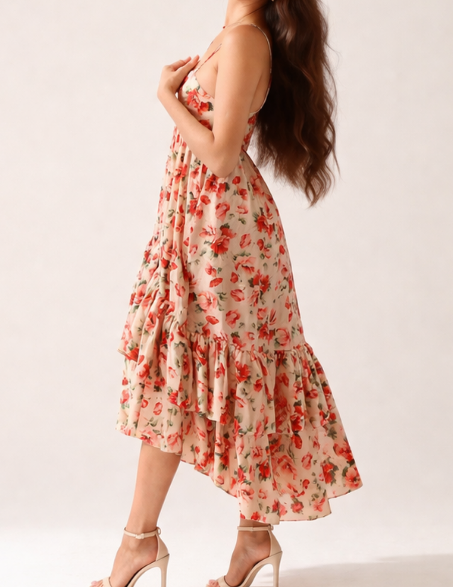 Woman wearing a floral dress on a plain background