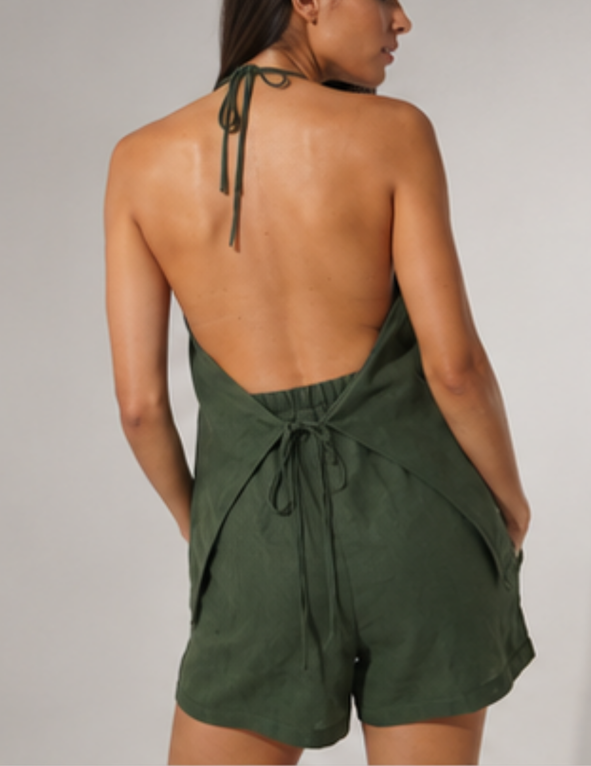Back view of the Maris Set showing the open back halter top, adjustable neck tie, back waist tie and shorts with pockets